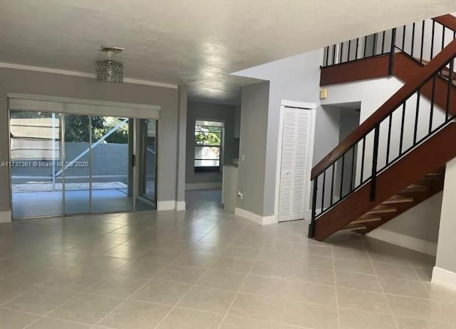 interior space featuring light tile patterned floors and crown molding