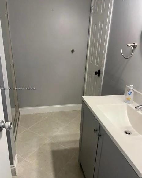 bathroom featuring tile patterned flooring and vanity