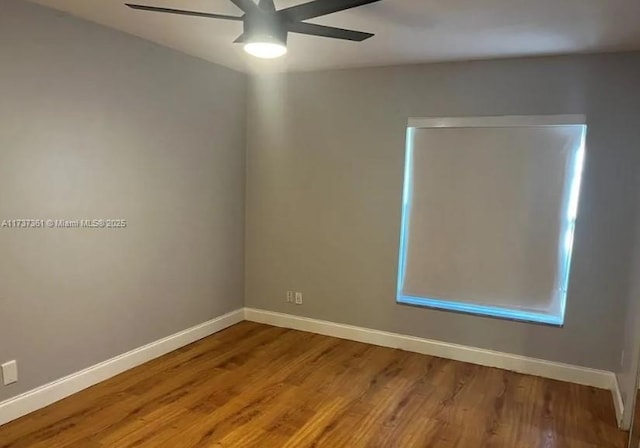 empty room with hardwood / wood-style flooring and ceiling fan