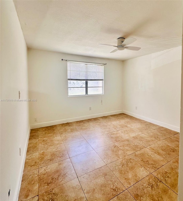 unfurnished room featuring ceiling fan, light tile patterned floors, and a textured ceiling