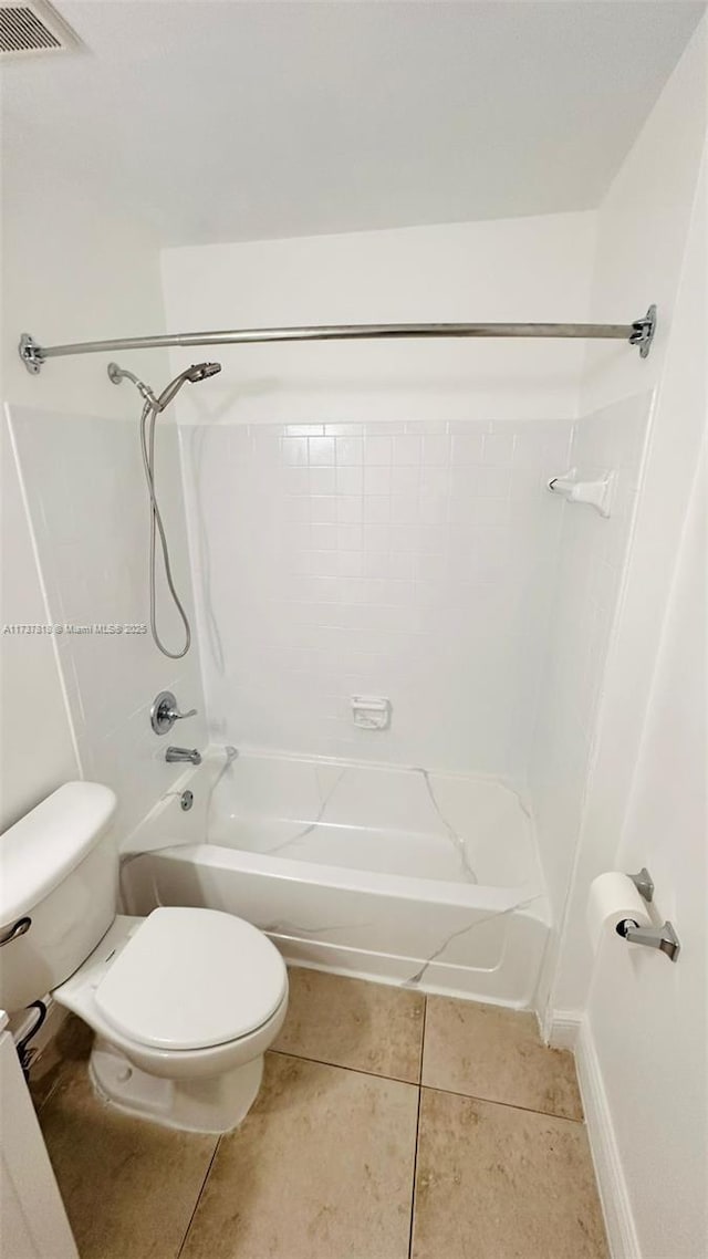 bathroom featuring tile patterned flooring, shower / bathing tub combination, and toilet