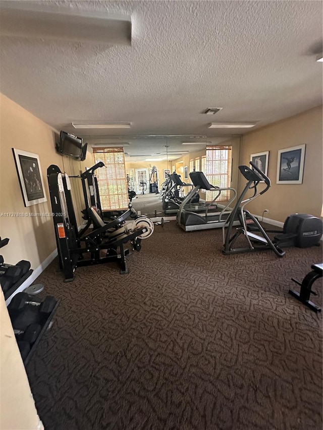 exercise room featuring a textured ceiling