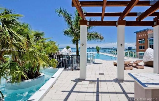 view of swimming pool with a pergola and a patio area