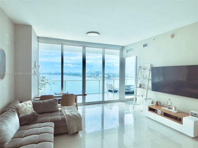 living room with light tile patterned floors and floor to ceiling windows