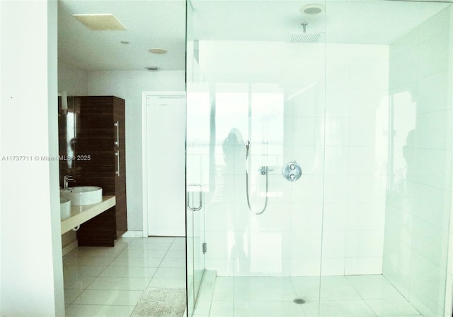 bathroom featuring vanity, tile patterned flooring, and walk in shower