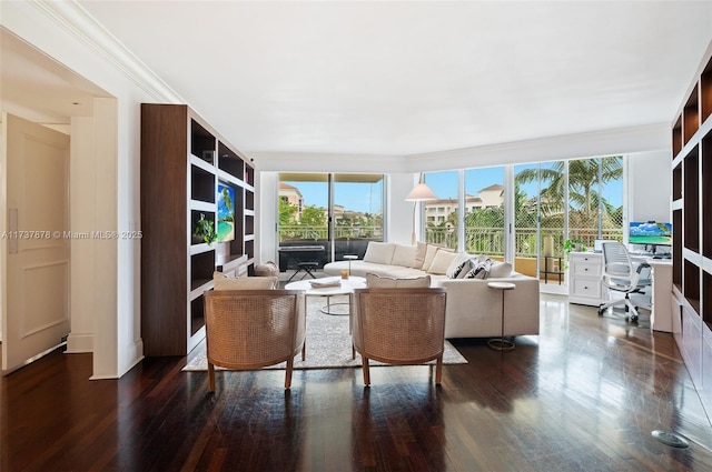 living area with ornamental molding and wood finished floors