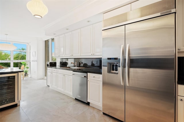 kitchen featuring a sink, wine cooler, white cabinets, appliances with stainless steel finishes, and dark countertops