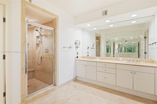 bathroom featuring baseboards, visible vents, double vanity, a stall shower, and a sink