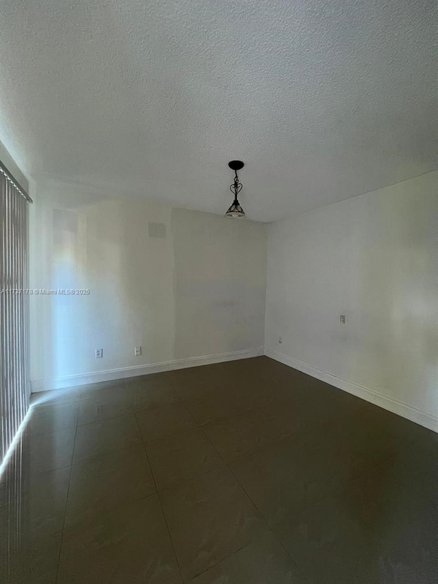 unfurnished room featuring a textured ceiling