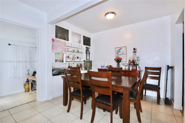 dining room with light tile patterned floors and built in features