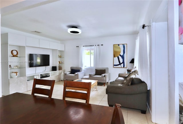 living area featuring light tile patterned floors and visible vents