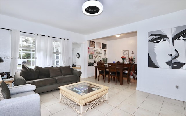 living room featuring baseboards and light tile patterned flooring