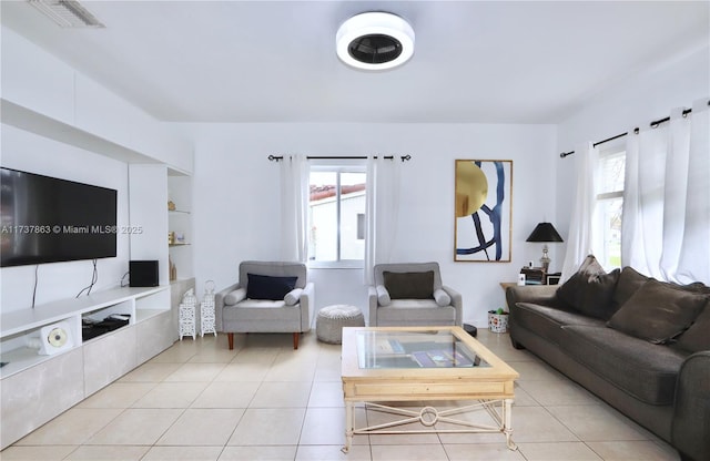 living room with light tile patterned floors and visible vents