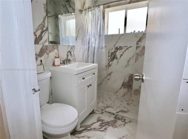 bathroom with curtained shower, marble finish floor, vanity, and toilet