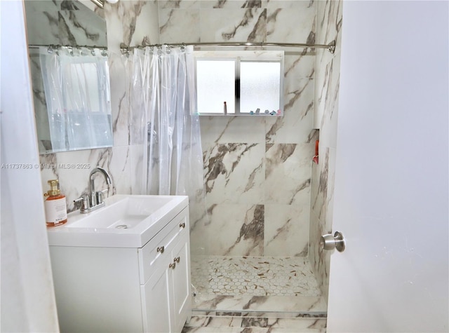 full bathroom featuring tile walls, vanity, and a shower with shower curtain