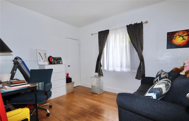 office space featuring baseboards and wood finished floors