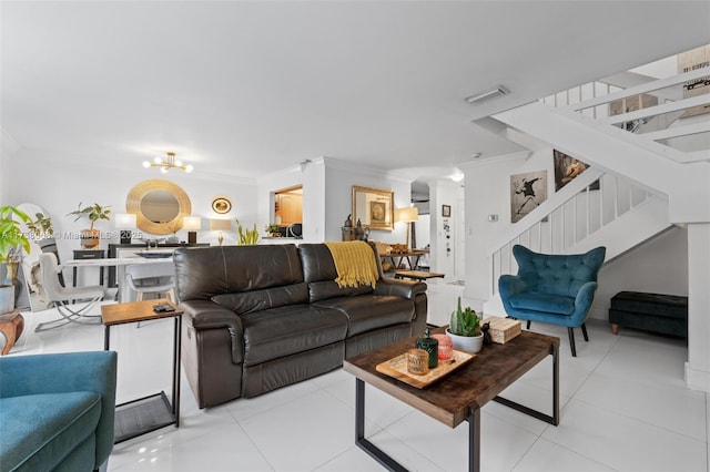 living room featuring an inviting chandelier, crown molding, and light tile patterned flooring