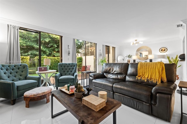 living room featuring crown molding, a notable chandelier, and light tile patterned floors