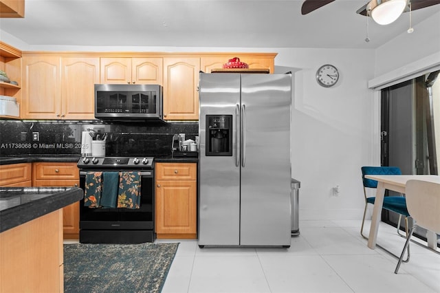 kitchen with light tile patterned floors, light brown cabinets, appliances with stainless steel finishes, ceiling fan, and backsplash