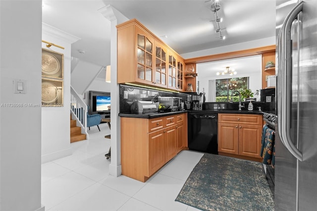 kitchen with light tile patterned floors, sink, dark stone countertops, backsplash, and stainless steel appliances