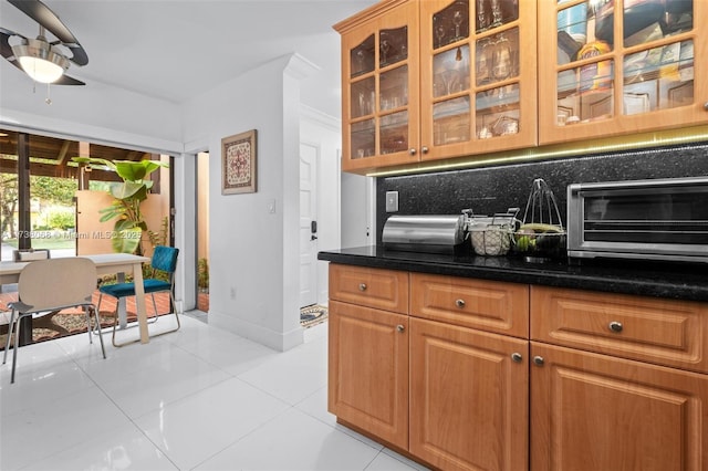 kitchen with light tile patterned floors, ceiling fan, and decorative backsplash