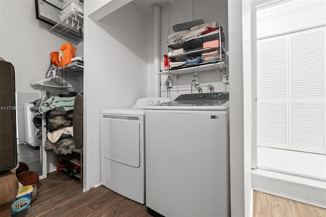 laundry area with separate washer and dryer and dark hardwood / wood-style floors