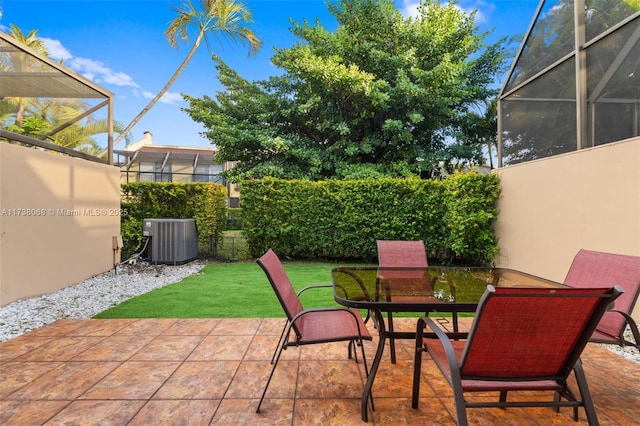 view of patio / terrace featuring central AC unit and a lanai