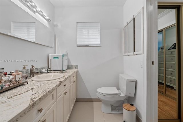 bathroom featuring vanity, toilet, and tile patterned flooring