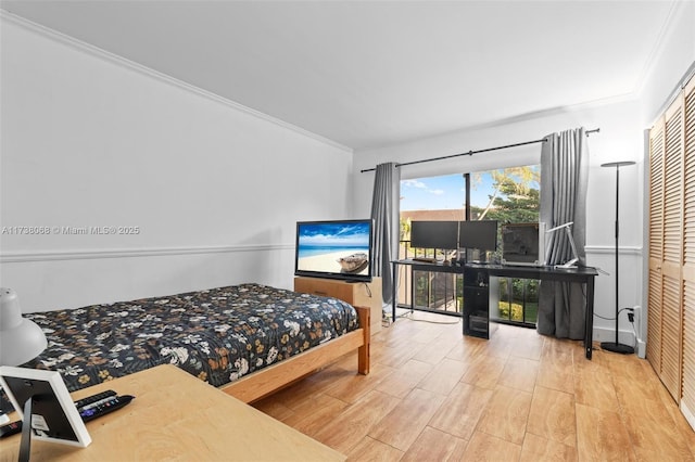 bedroom with access to exterior, hardwood / wood-style flooring, and ornamental molding