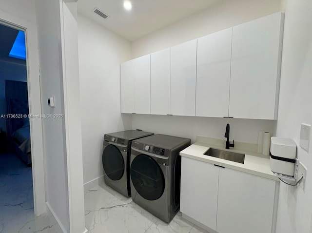 laundry room with sink, cabinets, and independent washer and dryer