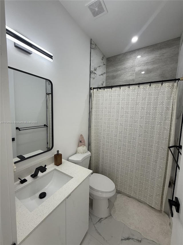 bathroom with vanity, toilet, and a shower with shower curtain