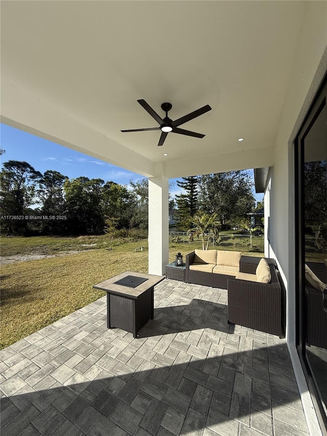 view of patio featuring an outdoor living space with a fire pit and ceiling fan