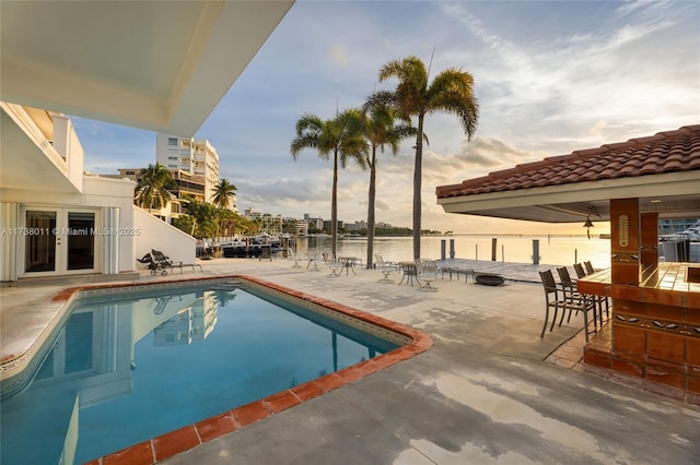 1740 S Bayshore Ln, Miami, FL 33133 - view of pool with a patio, a water view, and french doors