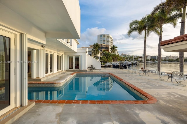 1740 S Bayshore Ln, Miami, FL 33133 - view of pool with french doors, a water view, and a patio area