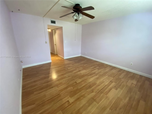 unfurnished room with hardwood / wood-style floors and ceiling fan