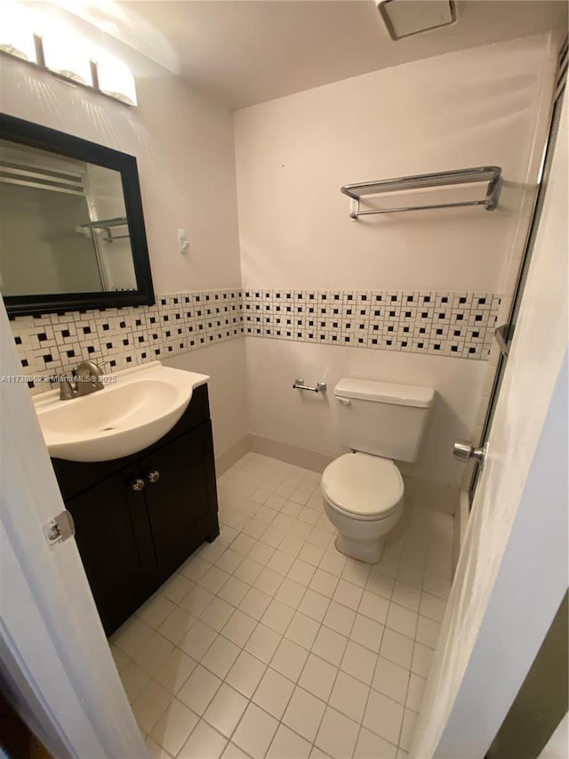 bathroom featuring vanity, backsplash, tile patterned floors, and toilet