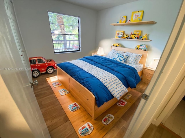 bedroom with dark wood-type flooring