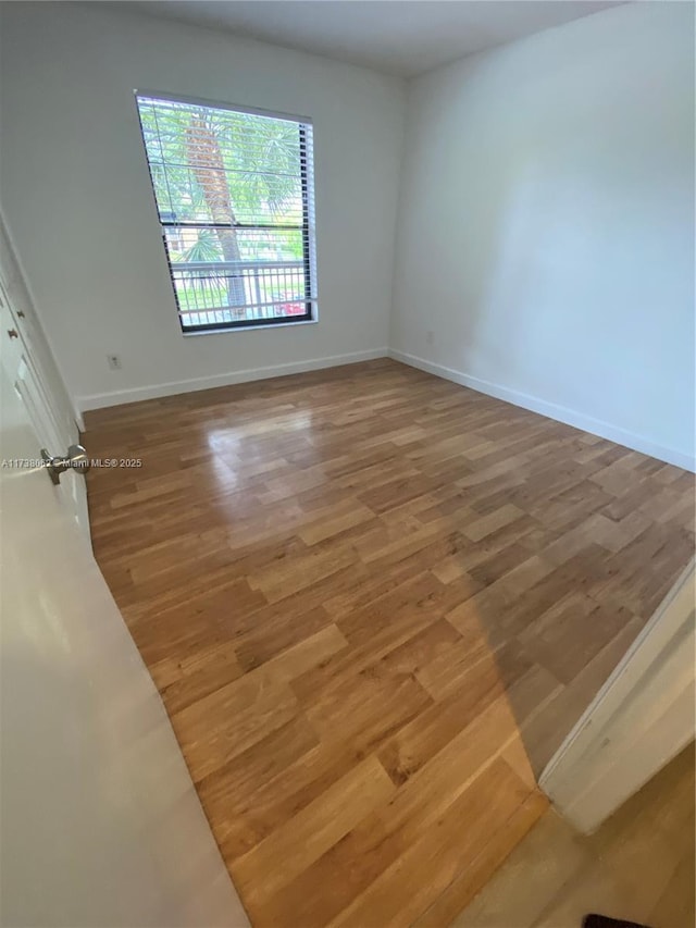 spare room featuring hardwood / wood-style floors