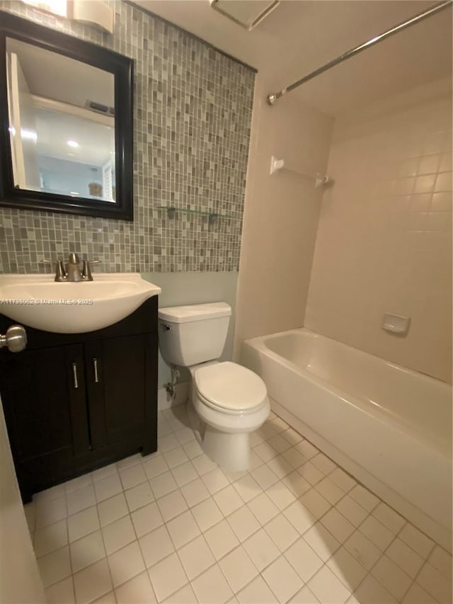 full bathroom featuring tile patterned flooring, vanity, tasteful backsplash, bathtub / shower combination, and toilet