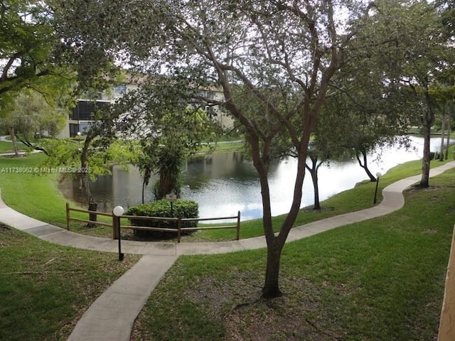 surrounding community featuring a water view and a yard