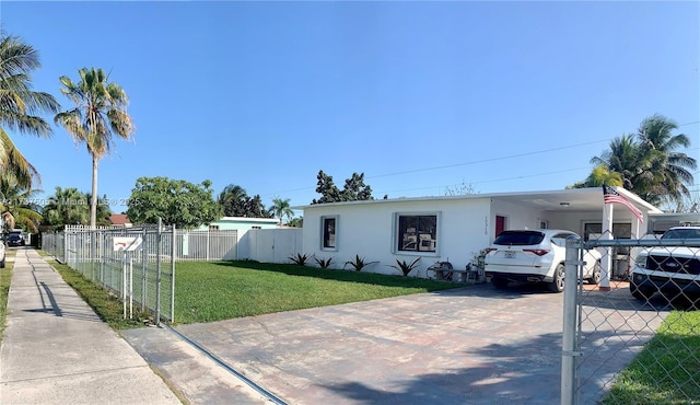 view of front of property with a front yard and a carport