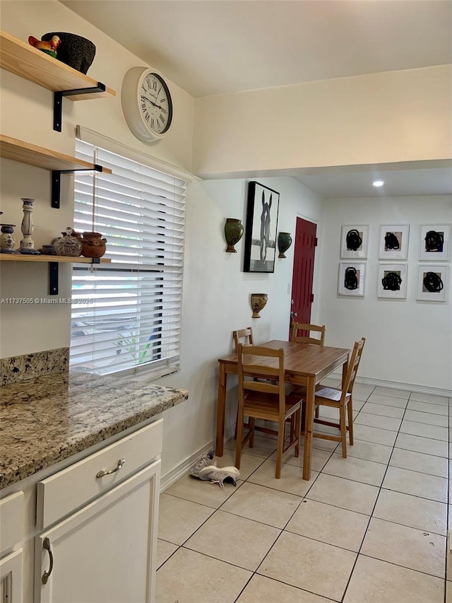 dining area featuring light tile patterned flooring