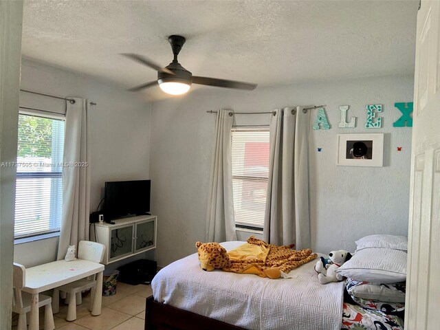 15310 Jackson Dr, Homestead, FL 33033 - bedroom featuring light tile patterned floors, a textured ceiling, and a ceiling fan