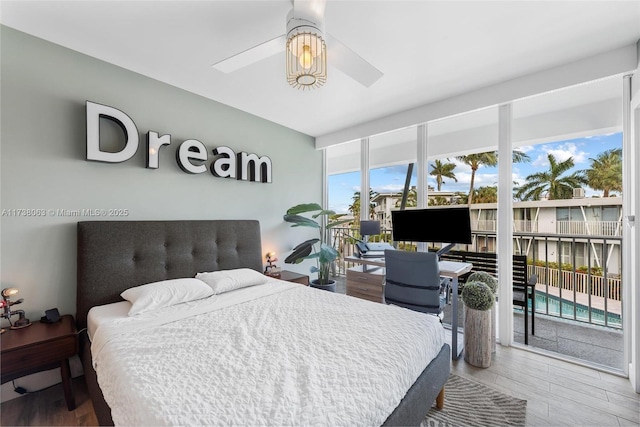 bedroom with ceiling fan, access to exterior, and hardwood / wood-style floors