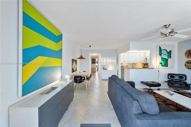 tiled living room featuring ceiling fan