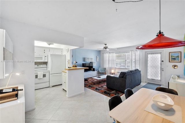 interior space featuring light tile patterned flooring and ceiling fan