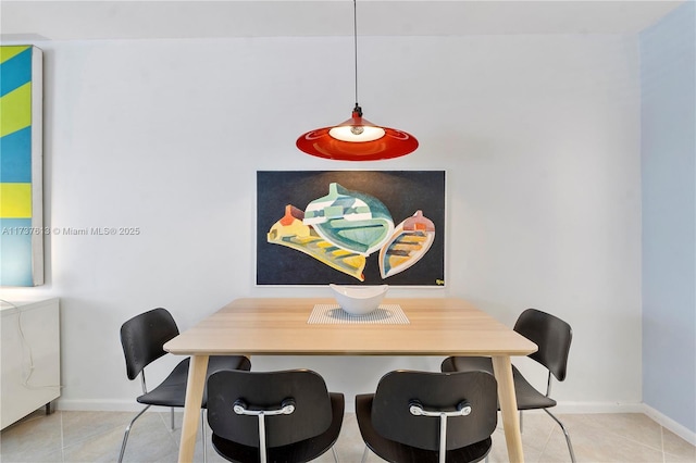 dining area featuring baseboards and tile patterned flooring