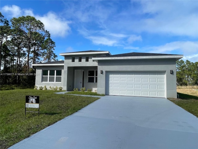 view of front of house featuring stucco siding, driveway, a front yard, and an attached garage