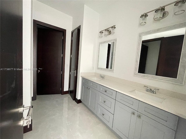 full bathroom featuring double vanity and a sink