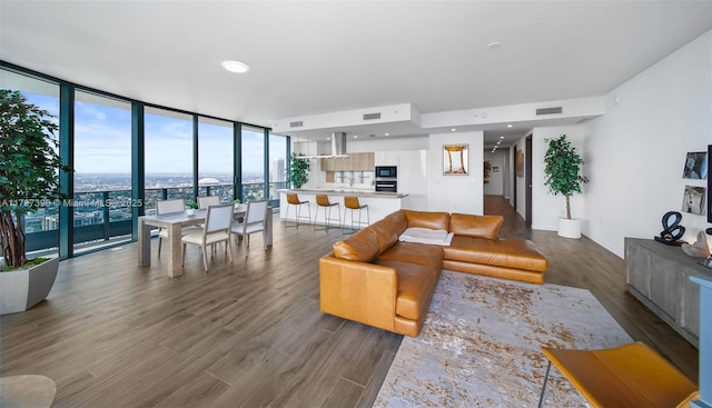 living room with floor to ceiling windows and dark hardwood / wood-style floors